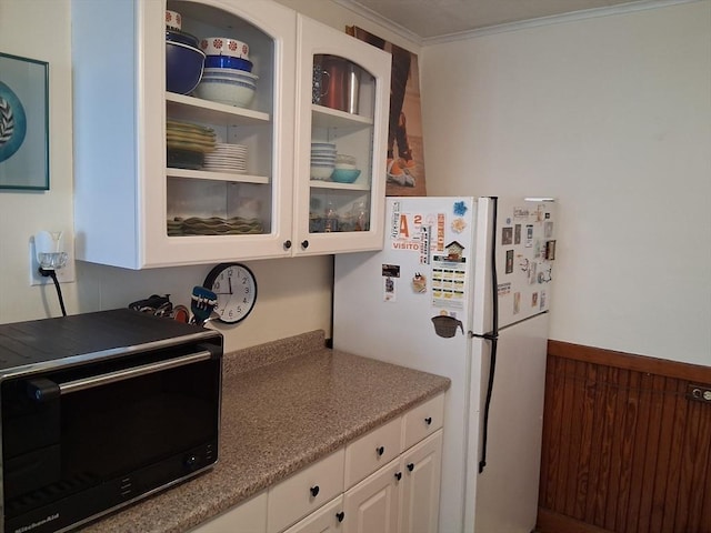 49-51 Sterling St, Somerville, MA 02144 - kitchen with freestanding refrigerator, glass insert cabinets, white cabinetry, black microwave, and crown molding