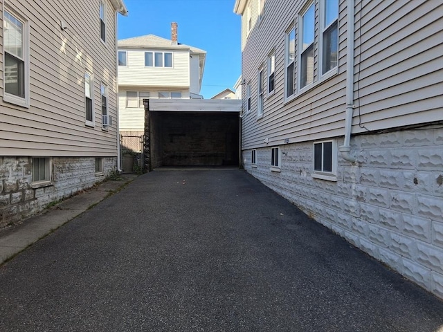49-51 Sterling St, Somerville, MA 02144 - view of property exterior with asphalt driveway and a carport