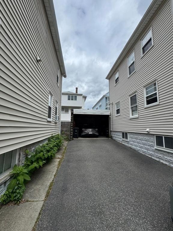 49-51 Sterling St, Somerville, MA 02144 - view of property exterior featuring an outbuilding