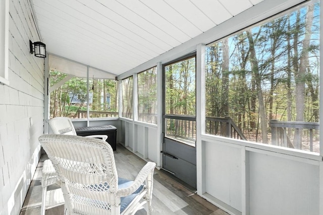 sunroom / solarium with plenty of natural light and vaulted ceiling