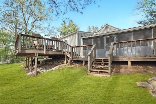 rear view of house featuring a sunroom, a deck, a yard, and stairway