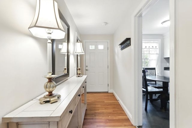 entryway with light wood-type flooring and baseboards