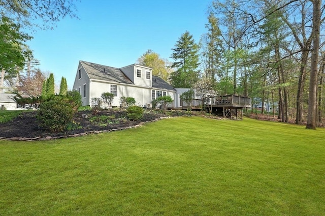 view of grassy yard with a wooden deck