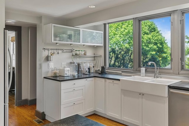 14 Meigh Rd, Newton, MA 02467 - kitchen with plenty of natural light, stainless steel appliances, white cabinets, light wood finished floors, and recessed lighting