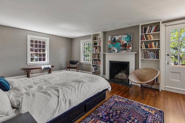 14 Meigh Rd, Newton, MA 02467 - bedroom with wood finished floors, a fireplace with flush hearth, and baseboards