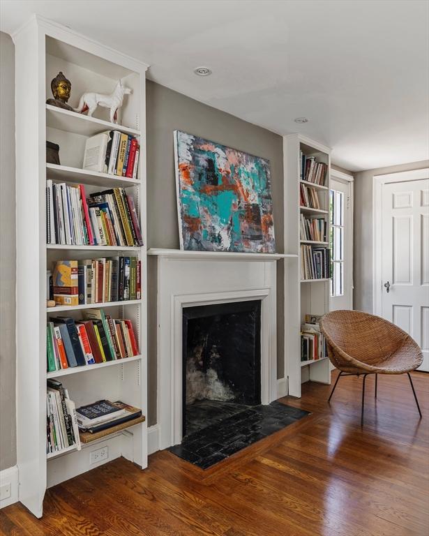 14 Meigh Rd, Newton, MA 02467 - living area with wood finished floors and a fireplace with flush hearth