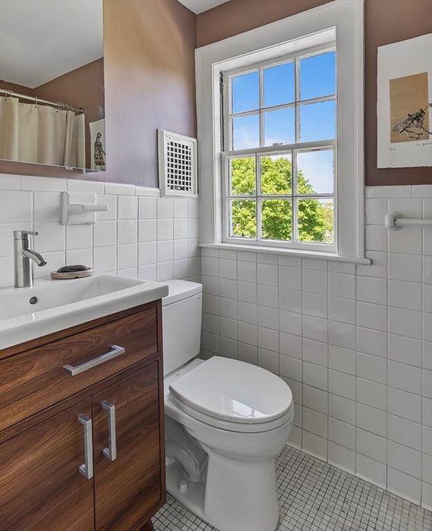 14 Meigh Rd, Newton, MA 02467 - full bath featuring tile walls, tile patterned floors, toilet, vanity, and wainscoting