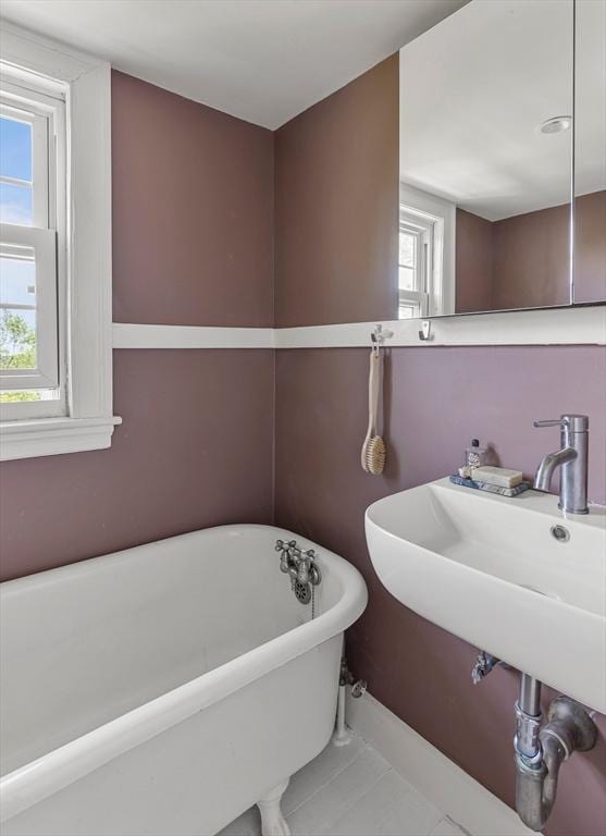 14 Meigh Rd, Newton, MA 02467 - full bathroom featuring a freestanding tub, plenty of natural light, tile patterned flooring, and baseboards