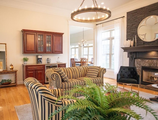 99 Elizabeth St, Agawam, MA 01030 - living area featuring a chandelier, ornamental molding, light wood-style flooring, and a fireplace