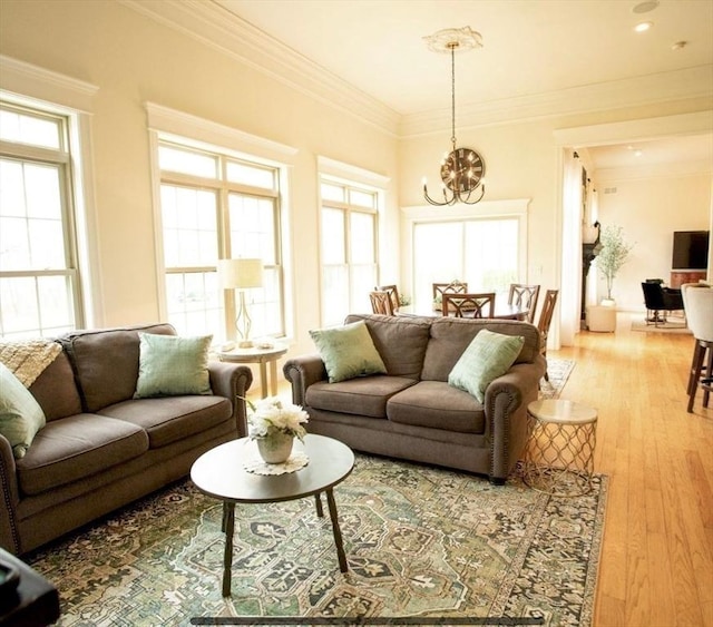 99 Elizabeth St, Agawam, MA 01030 - living room featuring a chandelier, ornamental molding, and light wood-style floors
