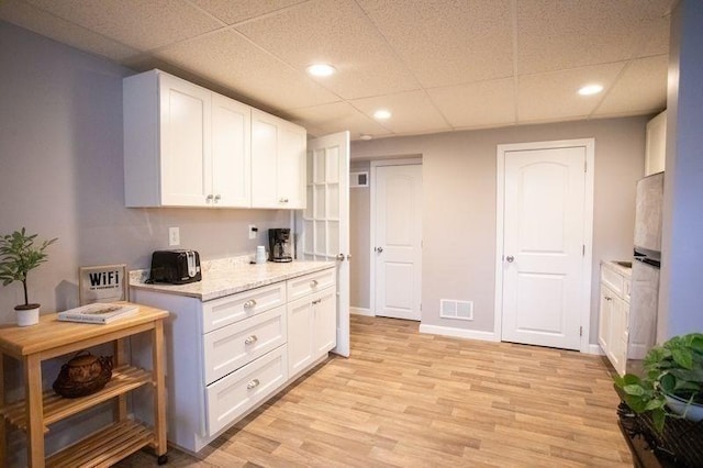 99 Elizabeth St, Agawam, MA 01030 - kitchen with a paneled ceiling, white cabinets, recessed lighting, and light wood-style flooring