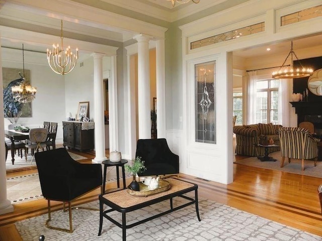 99 Elizabeth St, Agawam, MA 01030 - living room featuring a chandelier, wood finished floors, decorative columns, and ornamental molding