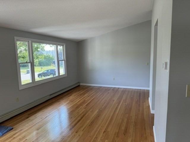 bathroom with toilet and baseboard heating