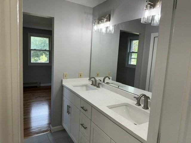 bathroom featuring a baseboard radiator, a healthy amount of sunlight, and vanity