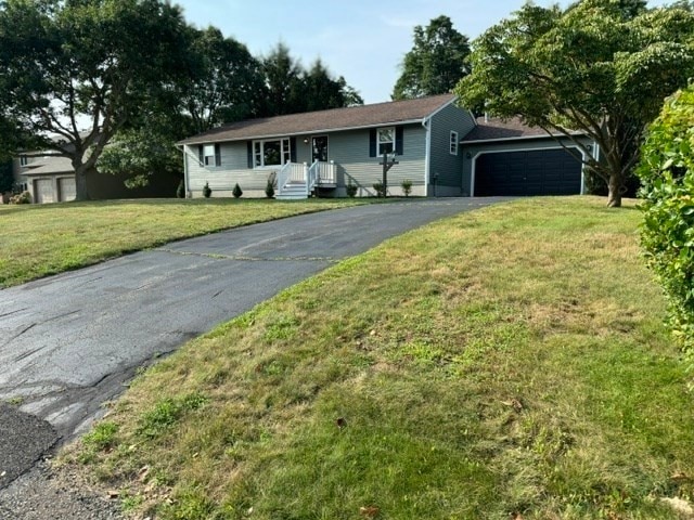 ranch-style house with a front lawn and a garage