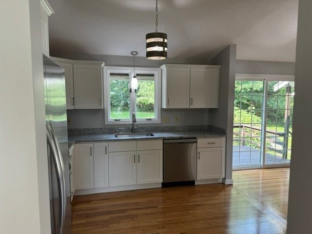 kitchen with sink, white cabinetry, and stainless steel appliances