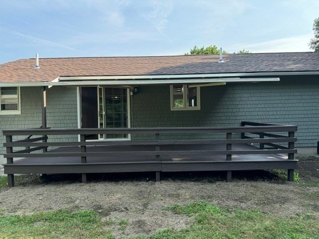 rear view of property featuring a deck