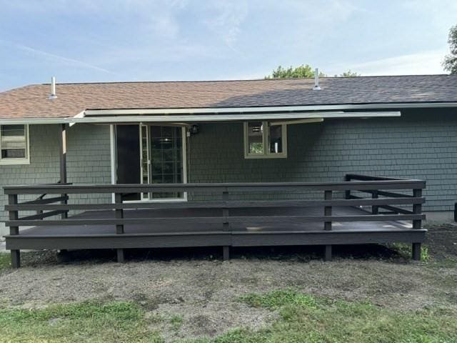 back of property featuring a wooden deck