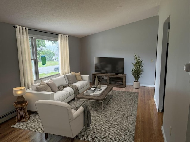 living room featuring wood-type flooring, a textured ceiling, and a baseboard radiator