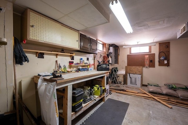 interior space featuring dark brown cabinetry, unfinished concrete floors, visible vents, and light countertops