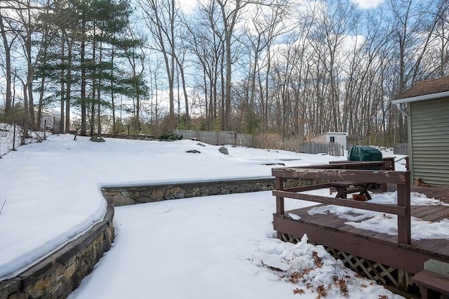 snowy yard featuring fence