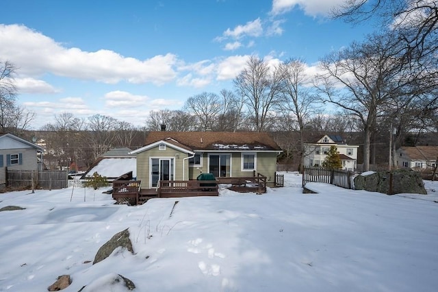 view of front of property with fence and a deck