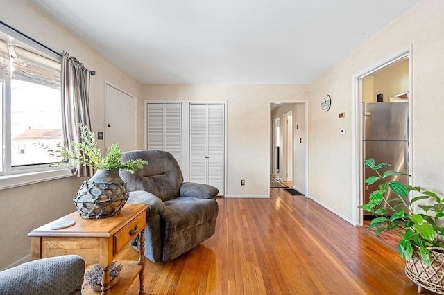 living area featuring wood finished floors and baseboards