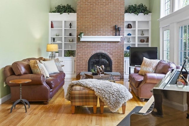 32 Bulkley Rd, Sudbury, MA 01776 - living room with wood finished floors, a fireplace, baseboards, and built in features