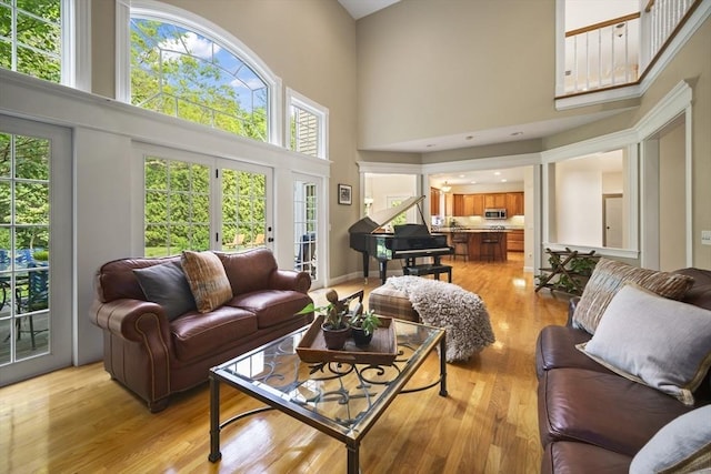 32 Bulkley Rd, Sudbury, MA 01776 - living room featuring a towering ceiling, light wood finished floors, and healthy amount of natural light