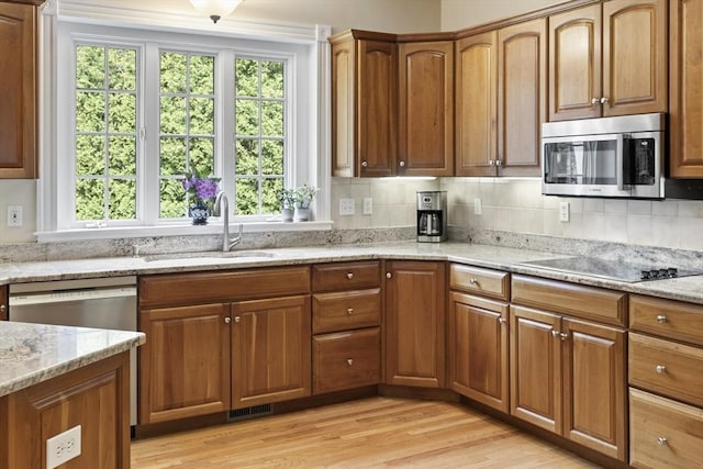 32 Bulkley Rd, Sudbury, MA 01776 - kitchen with appliances with stainless steel finishes, a sink, light wood-type flooring, and healthy amount of natural light