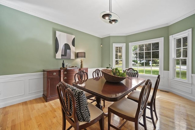 32 Bulkley Rd, Sudbury, MA 01776 - dining room with light wood-style floors, crown molding, wainscoting, and a decorative wall