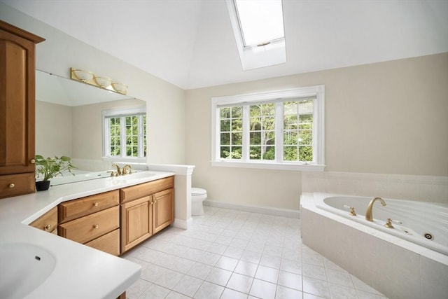 32 Bulkley Rd, Sudbury, MA 01776 - bathroom featuring vanity, baseboards, a whirlpool tub, a skylight, and tile patterned floors