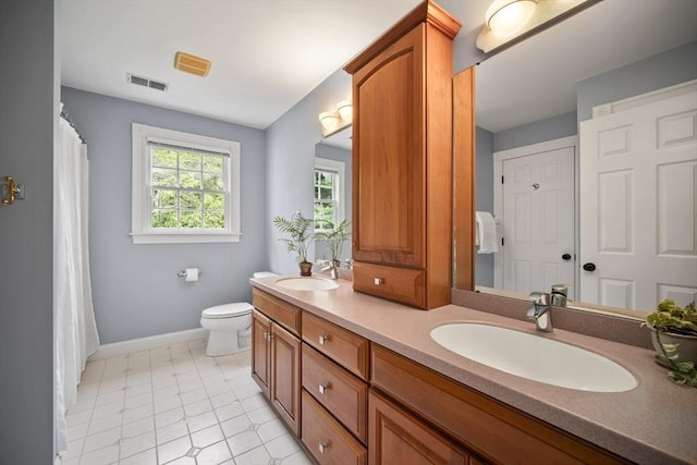 32 Bulkley Rd, Sudbury, MA 01776 - bathroom with double vanity, baseboards, toilet, and a shower with shower curtain
