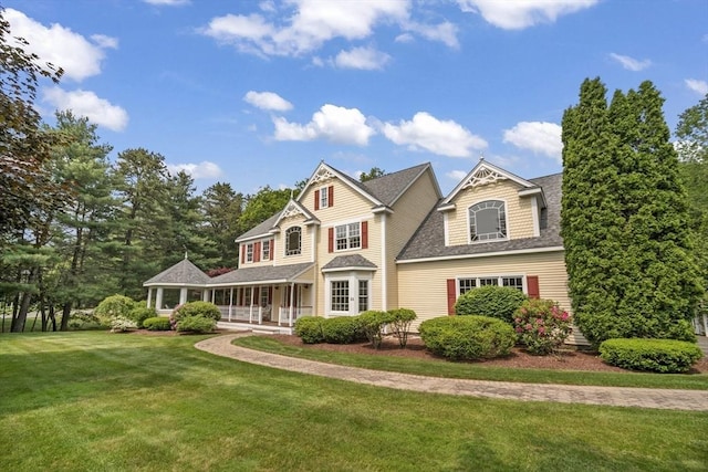 32 Bulkley Rd, Sudbury, MA 01776 - view of front of property with a shingled roof, covered porch, and a front lawn