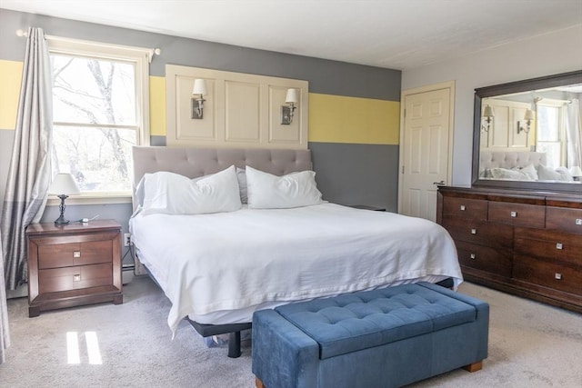 bedroom featuring multiple windows and light carpet