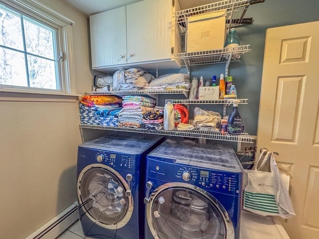laundry area featuring washer and dryer, baseboards, a baseboard radiator, and cabinet space