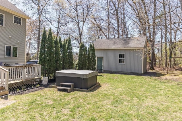 view of yard with a hot tub, an outbuilding, and a wooden deck