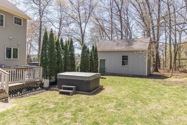 view of yard featuring a hot tub, an outbuilding, and a deck