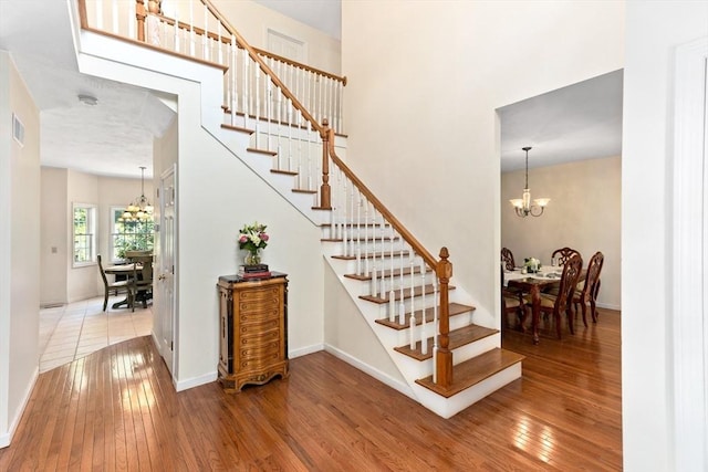 31 Swing Dr, Berkley, MA 02779 - stairway featuring a chandelier and hardwood / wood-style flooring