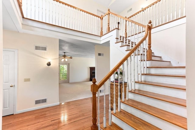 31 Swing Dr, Berkley, MA 02779 - stairway with wood finished floors, a ceiling fan, and a high ceiling