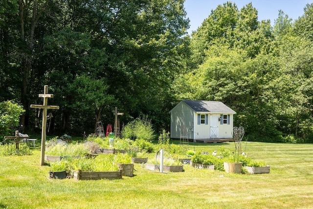 31 Swing Dr, Berkley, MA 02779 - view of green lawn featuring a vegetable garden, a shed, and a wooded view