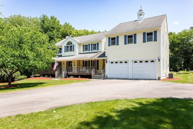31 Swing Dr, Berkley, MA 02779 - view of front of property featuring asphalt driveway, an attached garage, a porch, and a front yard