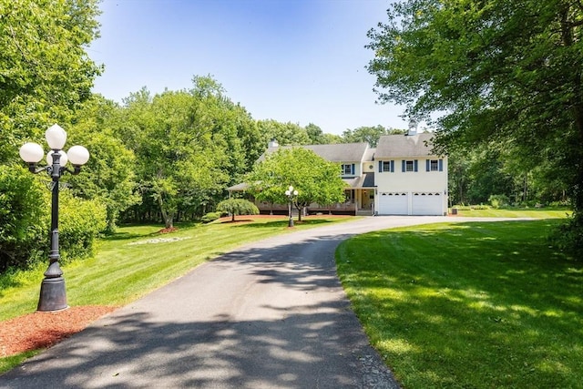 31 Swing Dr, Berkley, MA 02779 - view of front of house featuring an attached garage, driveway, and a front yard
