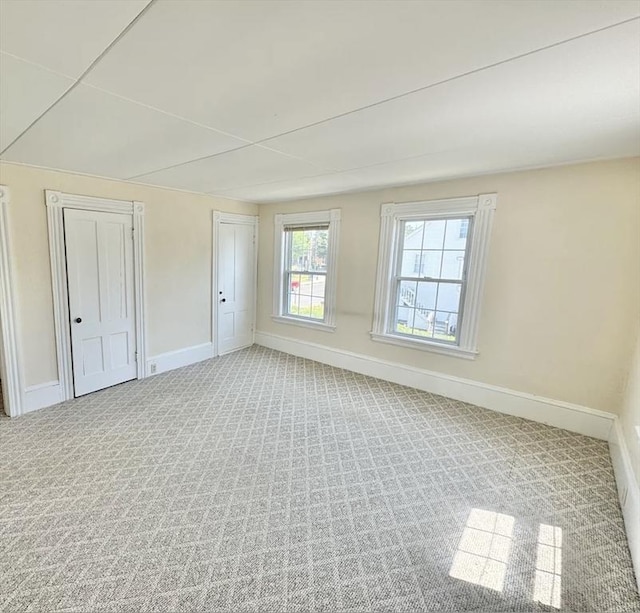 unfurnished bedroom with carpet flooring and baseboards