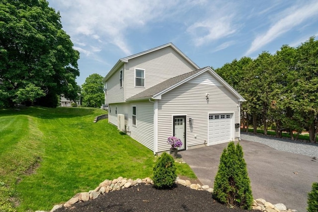 27 Joy St, Johnston, RI 02919 - view of side of property with driveway, a garage, and a lawn