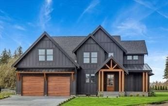 view of front of house with a garage and a front lawn