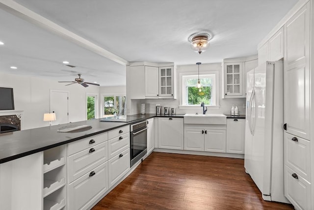 8 Winthrop Ave, Bedford, MA 01730 - kitchen featuring stainless steel oven, freestanding refrigerator, dark countertops, a peninsula, and recessed lighting