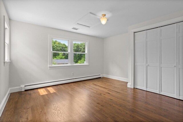 8 Winthrop Ave, Bedford, MA 01730 - unfurnished bedroom featuring a baseboard radiator, wood finished floors, and a closet