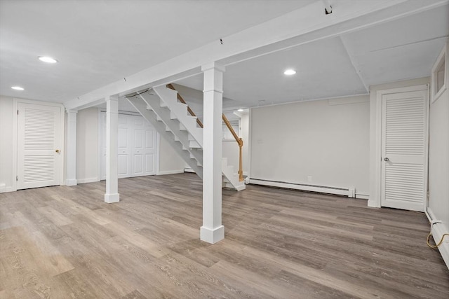 8 Winthrop Ave, Bedford, MA 01730 - finished below grade area featuring a baseboard radiator, stairway, wood finished floors, and recessed lighting