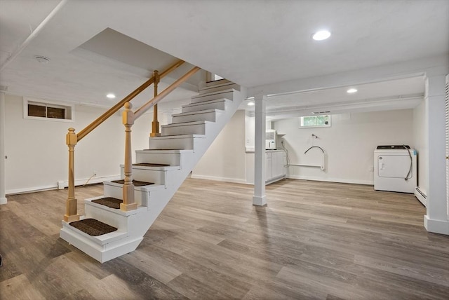 8 Winthrop Ave, Bedford, MA 01730 - below grade area with washer / clothes dryer, stairs, wood finished floors, recessed lighting, and a baseboard heating unit